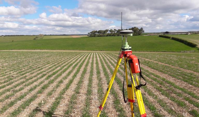 survey tripod and equipment in a field